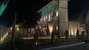 A modern building with a glass facade and a staircase leading to the entrance. - VILLA CRIS (Fernando de Noronha)