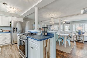 Enjoy cooking in this stylish kitchen with a central island, modern appliances, and a dining area.