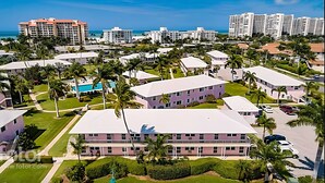 A resort with multiple buildings, a pool, and palm trees. - Fully remodeled 1/1 apartment (Marco Island)
