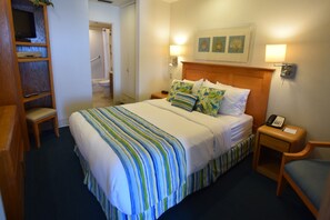 A hotel room with a large bed, bedside tables, a TV, a desk, and a chair. - Laguna Surf (Laguna Beach)