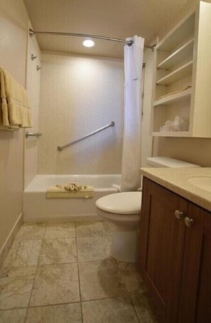 A bathroom with a bathtub, toilet, and a shower area. - Laguna Surf (Laguna Beach)