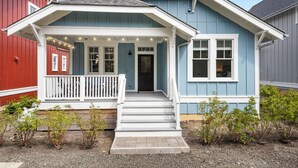 A two-story house with a porch, a front door, and a small garden area. - *NEW* Coastal Oasis, Hot Tub! (Pacific Beach)