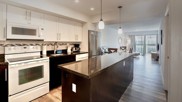 A modern kitchen with white cabinetry, stainless steel appliances, and a central island. - 2 bedroom apt near beach w/pool (Sunny Isles Beach)