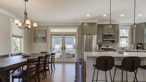 A modern kitchen with a dining area, stainless steel appliances, and a view to the outside. - *NEW* Seabrook's On The Rocks: Hot Tub & Dog Friendly (Pacific Beach)