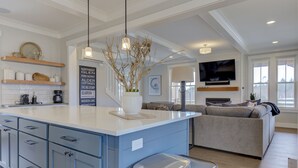 A modern kitchen with blue cabinets, a central island, and a built-in stove. - *NEW* Sand by Me, a beautifully furnished farmhouse! (Pacific Beach)