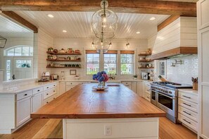 Enjoy cooking in this well-equipped kitchen with a large island, stove, and oven, plus ample storage and beautiful views.