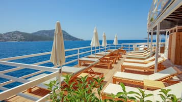Private beach, black sand, sun loungers, beach umbrellas