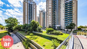 A modern apartment complex with multiple high-rise buildings, featuring balconies and a well-maintained green space in front. - Beautiful condo with Swimming Pool  and 24/7 security (Córdoba)