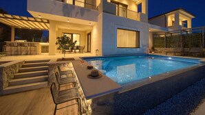 A modern two-story house with a swimming pool, outdoor seating, and a covered patio area. - Villa LADY with heated pool, jacuzzi and sauna (Pinezići)