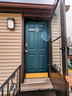 A dark blue door with a 'No Smoking' sign and the number '10' on it.
