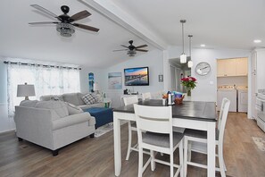 Relax in this inviting living space with a sofa, dining table, and kitchen area.