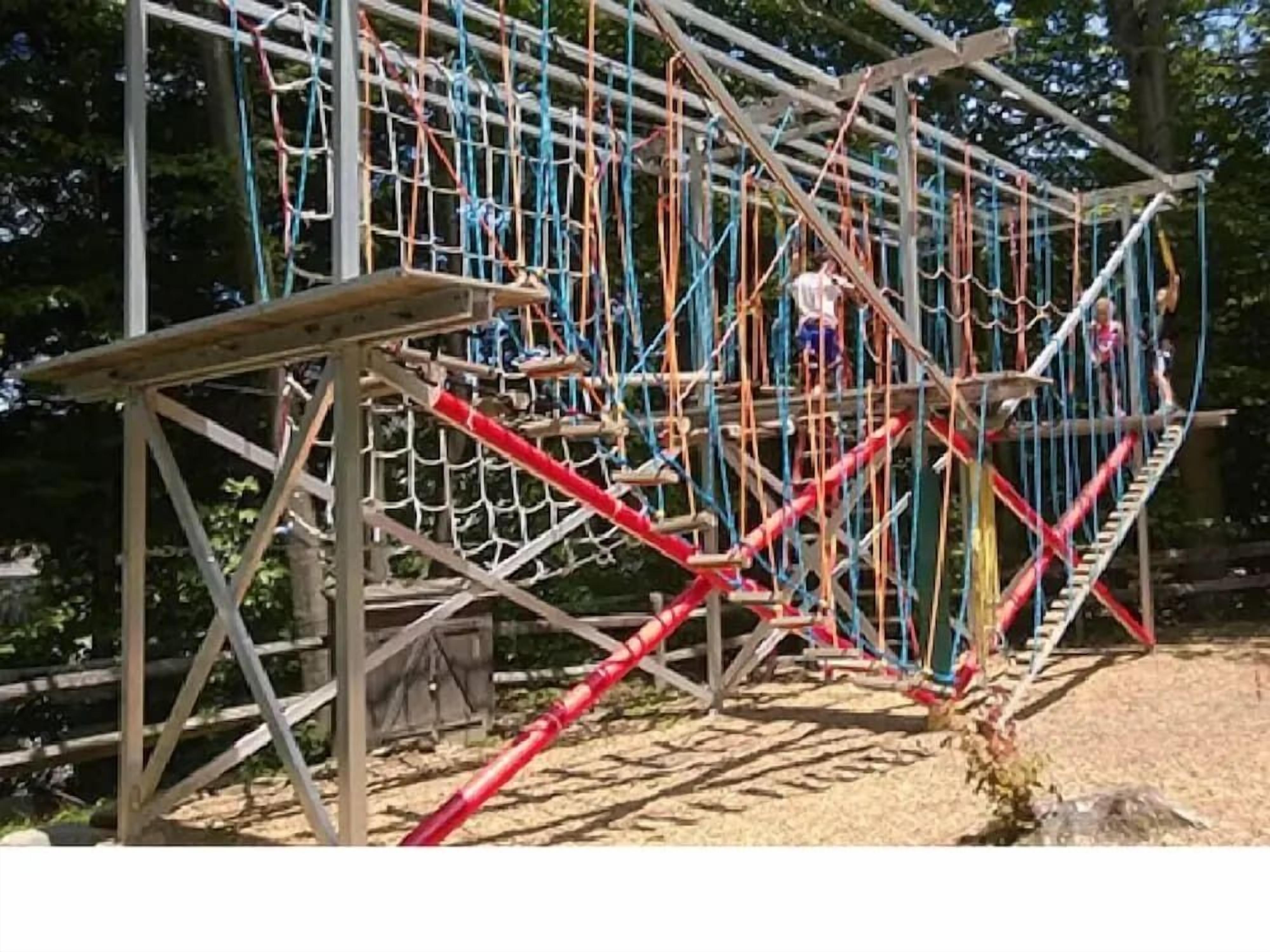 A rope bridge structure with multiple levels and a wooden platform.