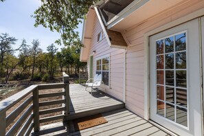A house with a deck, a window, and a door.