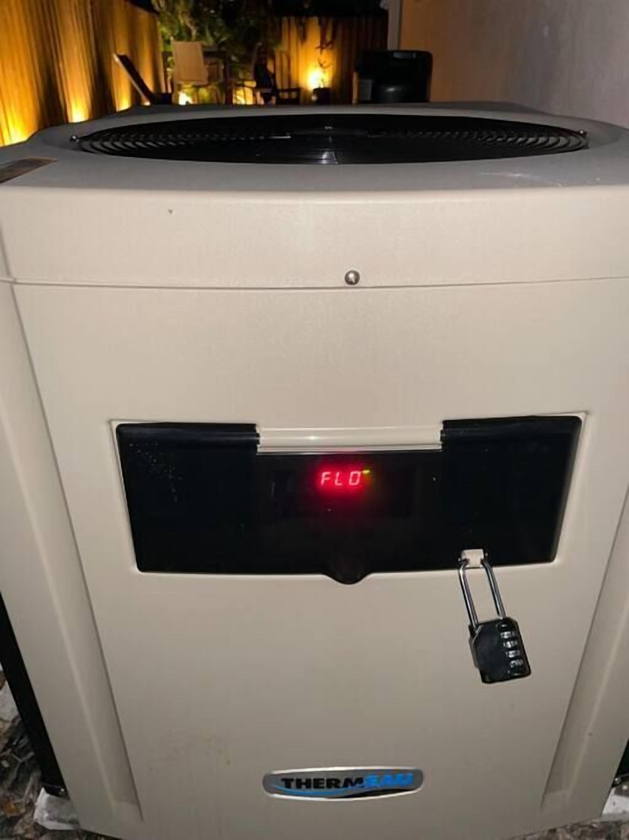 A white outdoor unit with a digital display reading "FLO" and a lock mechanism.