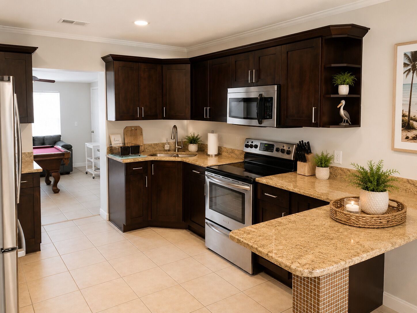 A modern kitchen with dark wood cabinets, stainless steel appliances, and a granite countertop.