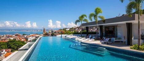 An infinity pool, sun loungers
