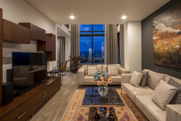 Presidential Penthouse, Sauna, Hill View | Living area | 55-inch Smart TV with cable channels, TV, toys - TOUCH AFRICA RESIDENCE (Kigali)