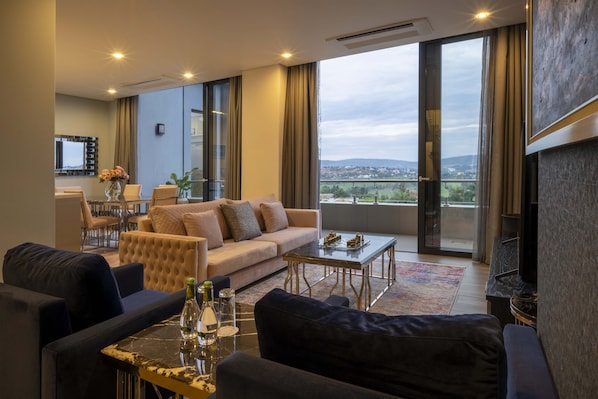 Signature Penthouse | Living area | 55-inch Smart TV with cable channels, TV, toys
