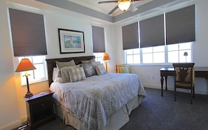 A bedroom with a bed, two bedside tables, a desk, and a chair. - Bonita Village "sunpearl" (Bonita Springs)