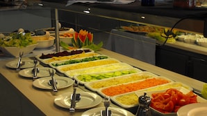 Un buffet proposant une variété de plats et d’ustensiles.