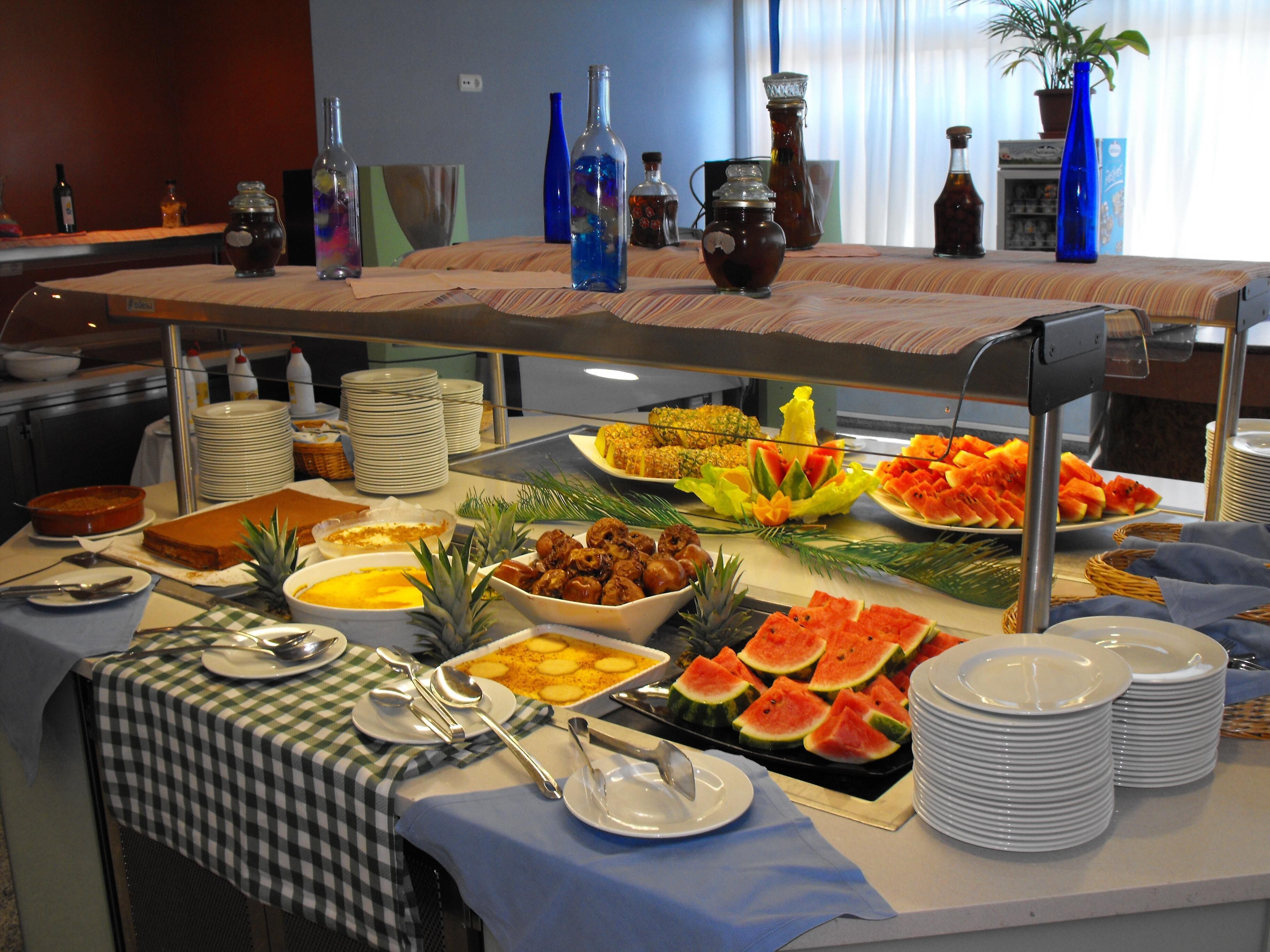 A buffet with various food items and beverages.