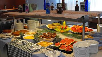 A buffet with various food items and beverages.