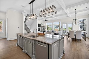 A spacious kitchen with a large island, built-in appliances, and pendant lighting. - Hermosa Manor - Luxury Vacation Rental House Near the Beach with Private Pool Area & Gulf Views (Santa Rosa Beach)