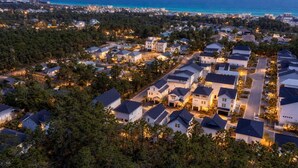 A residential area with houses, roads, and a coastline.