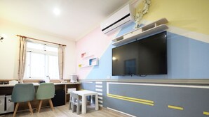 A compact kitchen with a TV, wooden cabinets, and a window with curtains. - Sun Moon Cat (Yuchi)