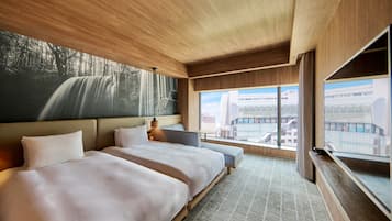 A hotel room with two beds, a large window with a city view, and a wooden ceiling.