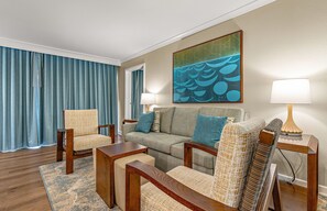 A hotel room with a sofa set, two armchairs, a coffee table, a side table with a lamp, and a painting on the wall. - Maui Resort Rentals: Marriott's Maui Ocean Club 1BR Mountain/Garden View Villa (Lahaina)