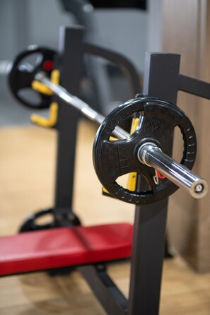A weightlifting bench with a barbell on a squat rack. - VIENTIANMEKONGHOTEL (Vientiane)