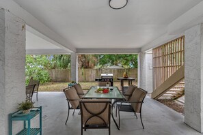 Relax outdoors with a table for four, a bowl of fresh fruit, and a bottle of wine.