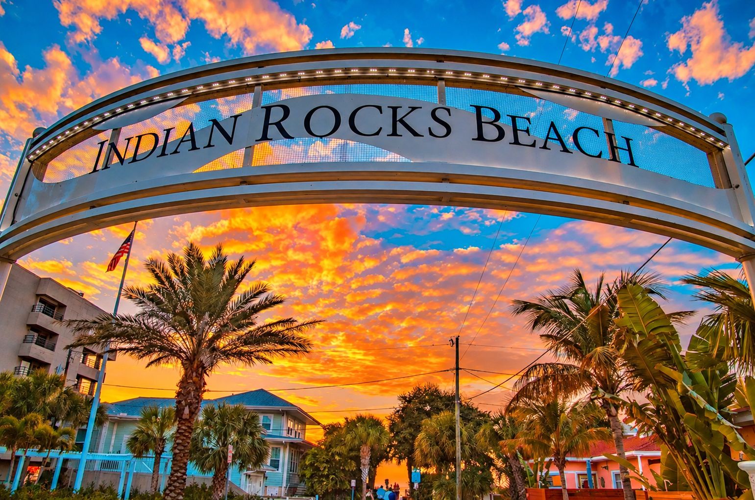 A sign for Indian Rocks Beach with a sunset sky.