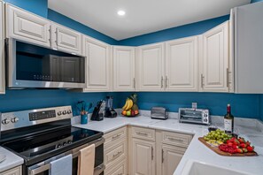 Enjoy cooking in this well-equipped kitchen with a stove, microwave, and toaster.