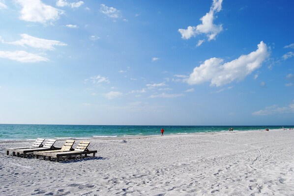 Relax on the beach with sun loungers and access to the calm sea.