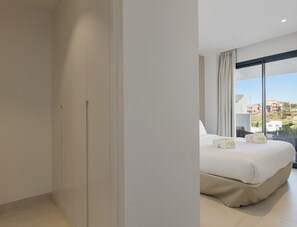 A hotel room with a large bed, a view of buildings through the window, and a balcony with curtains. - Deco | Pool - terrace - Fuengirola (Fuengirola)