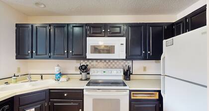 Comfortable townhome steps from beach with pool access, balcony, & W/D