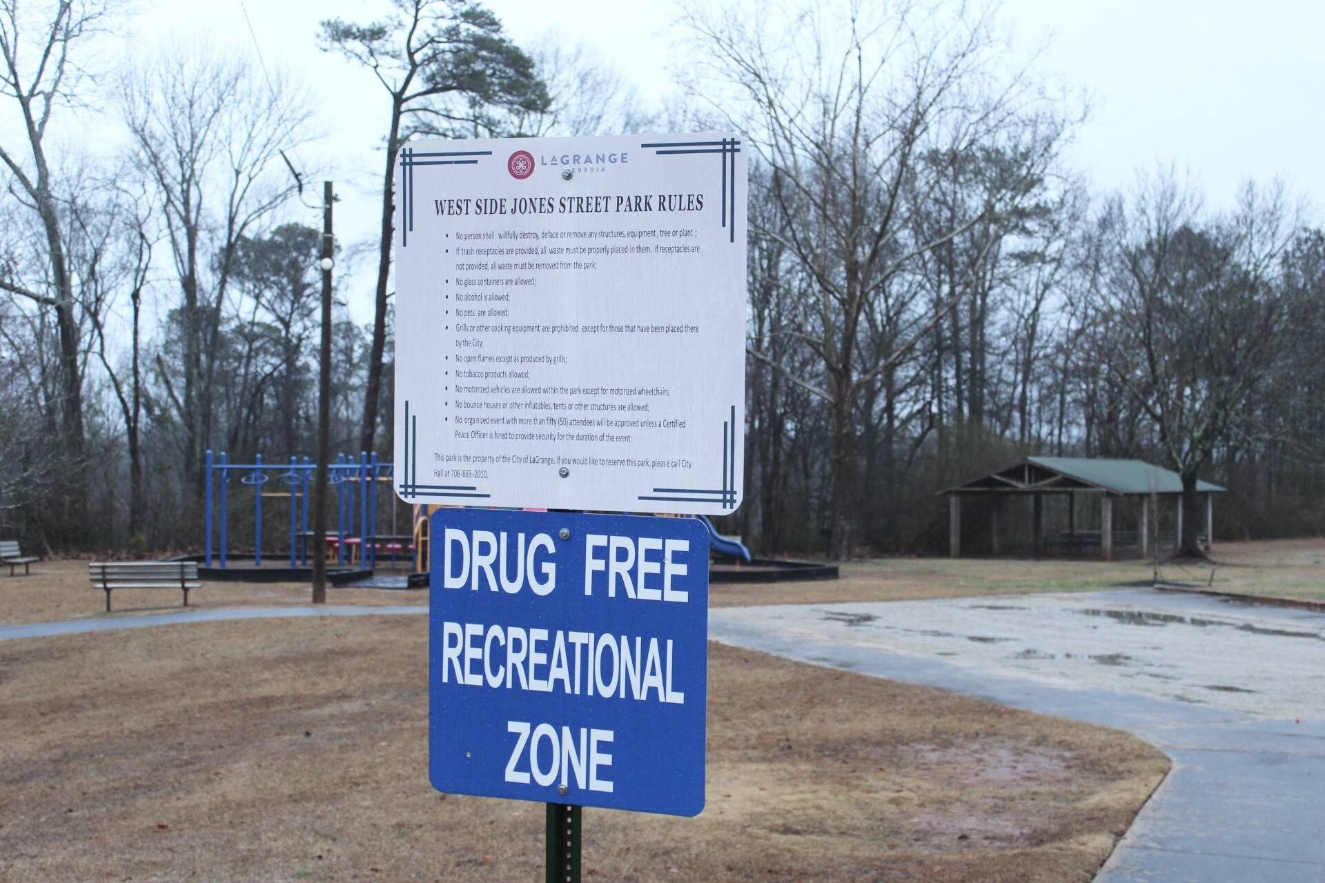 A park sign indicating West Side Jones Street Park Rules and a Drug Free Recreational Zone sign.