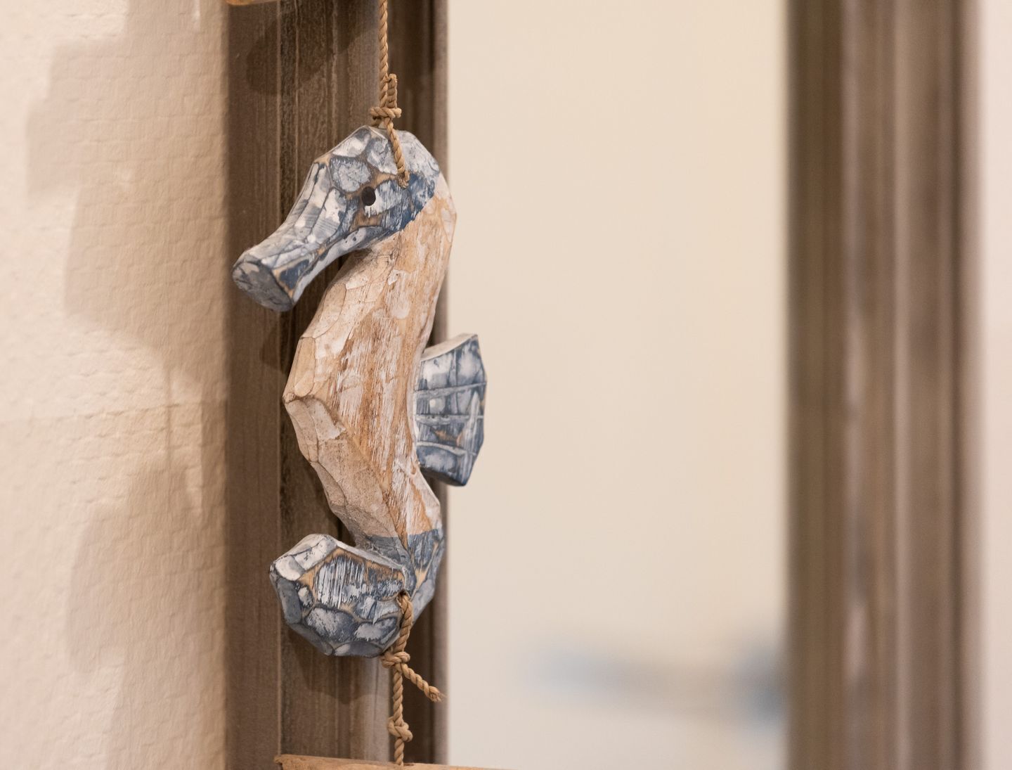A wooden door with a rope handle.