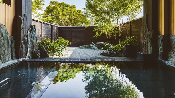A serene indoor pool area with a clear view of the surrounding garden and trees. - Etajimasou (Etajima)