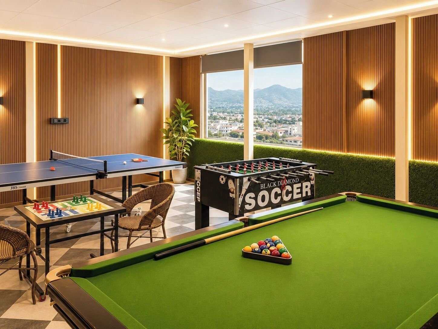 Una stanza con un tavolo da calcio, un biliardo e un tavolo da ping pong.