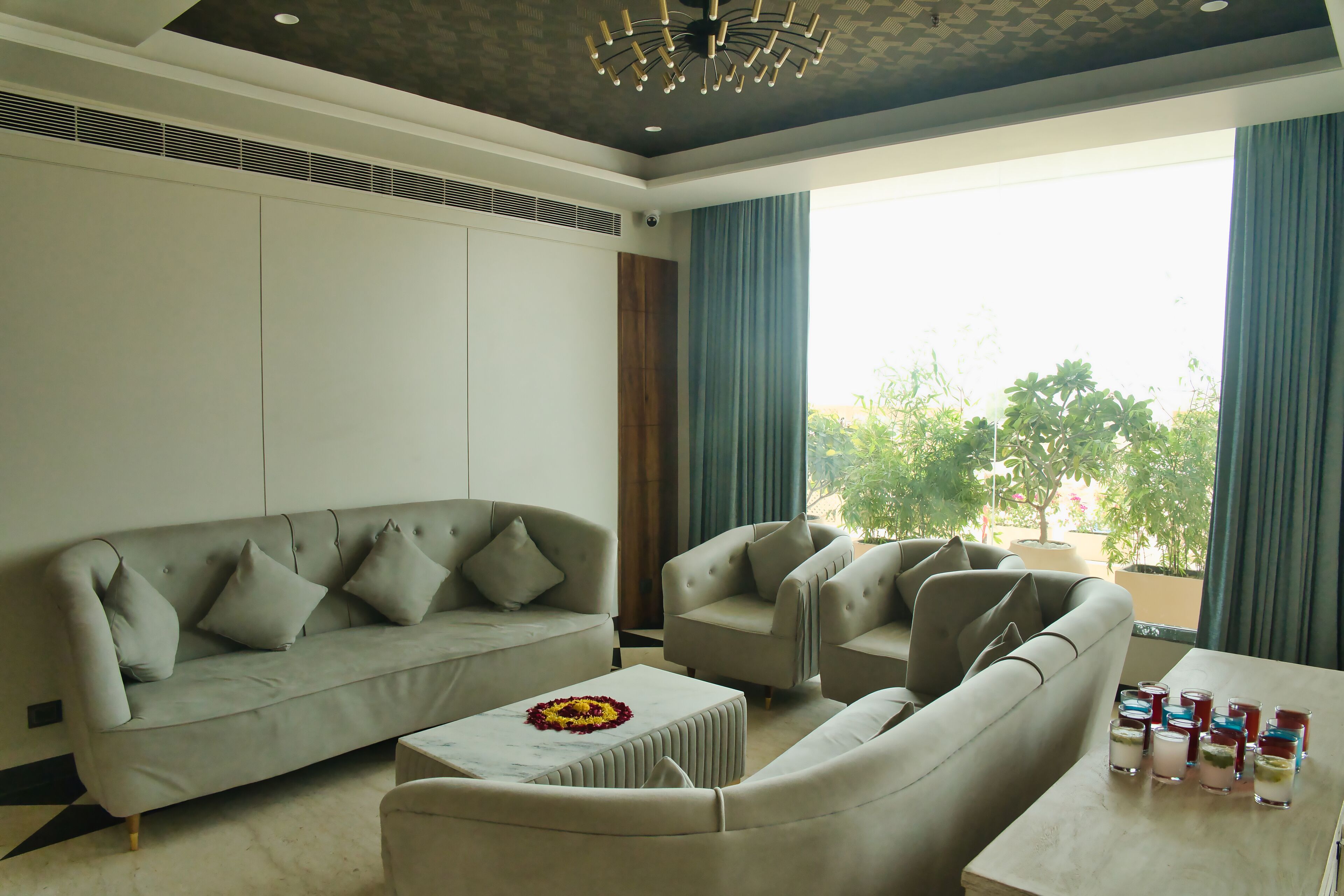 A modern living room with a sofa, armchairs, and a coffee table.
