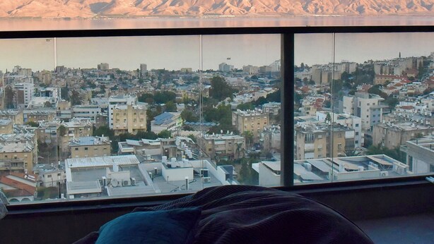 A cityscape with a view of mountains in the distance.