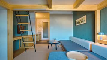 A modern living room with a wooden ladder, a small round table, and a sofa.