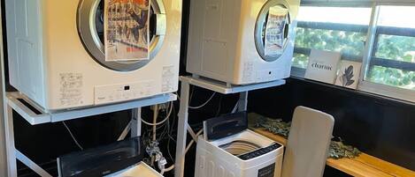 A laundry facility with multiple washing machines and dryers, arranged on a rack.