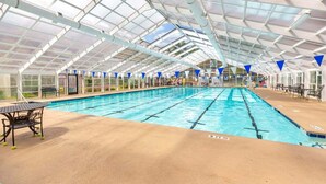 An indoor swimming pool with clear glass ceilings and blue triangular flags. - Marina Village 338 In Keowee Key (Salem)
