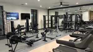 A gym with treadmills, weight machines, and free weights. - Jade At Millennium - 3 Bed Apt in Houston (Houston)