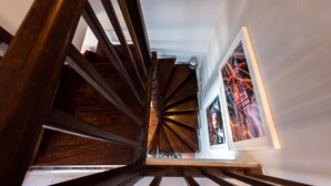A wooden staircase with a view of a framed artwork on the wall. - MONTMARTRE, PARIS VIEW, ATTRACTIONS, 30–60 days ahead? Ask Private offer VIE-VAp (Paris)