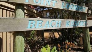 A wooden sign with the text 'POINT LOOKOUT BEACH RESORT'. - Straddie Breeze - A gorgeous fully renovated beachside apartment (Point Lookout)